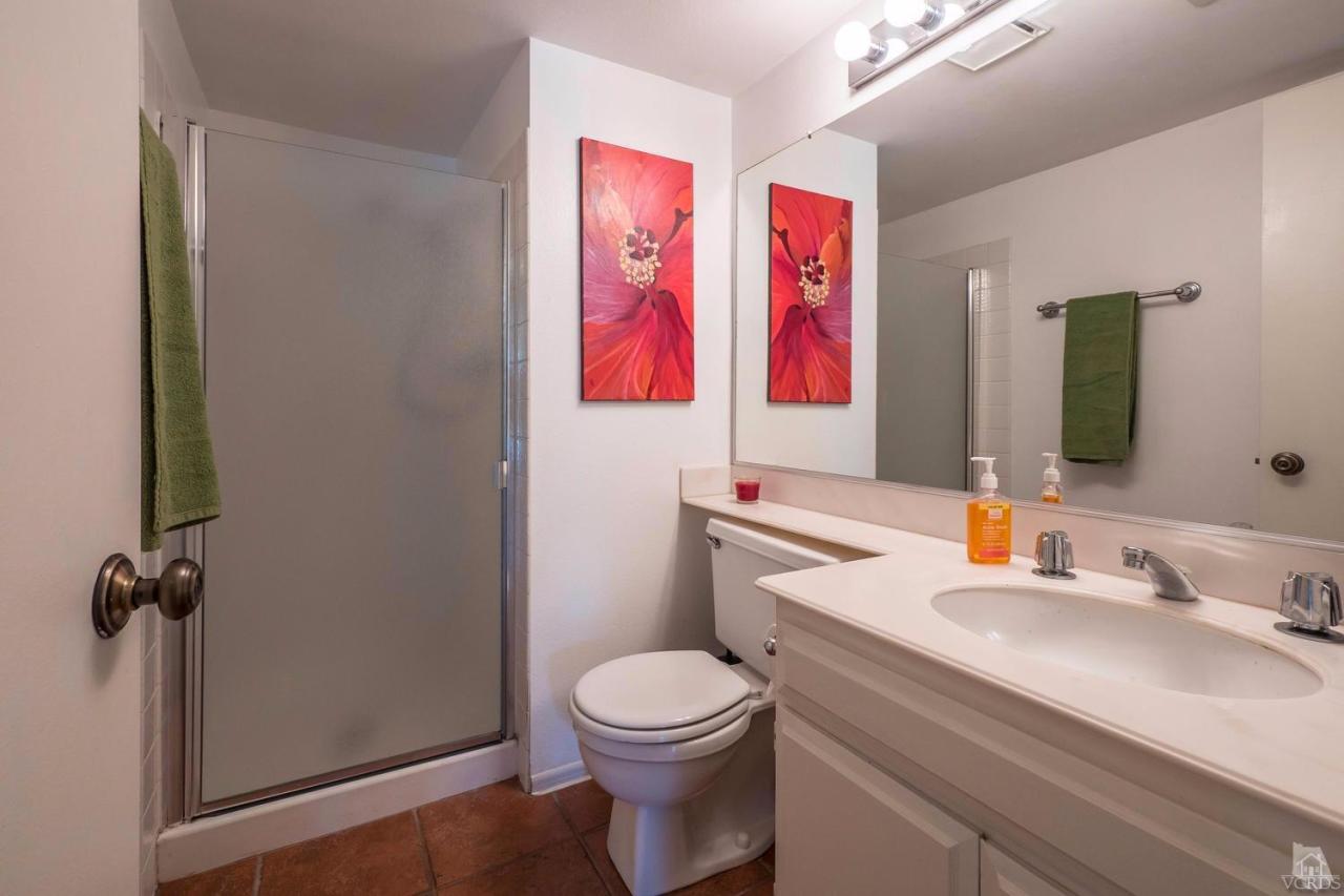 11529 East Buttercreek Road Moorpark, CA 93021 - Photo 17 of 36 a bathroom with a toilet sink vanity and mirror