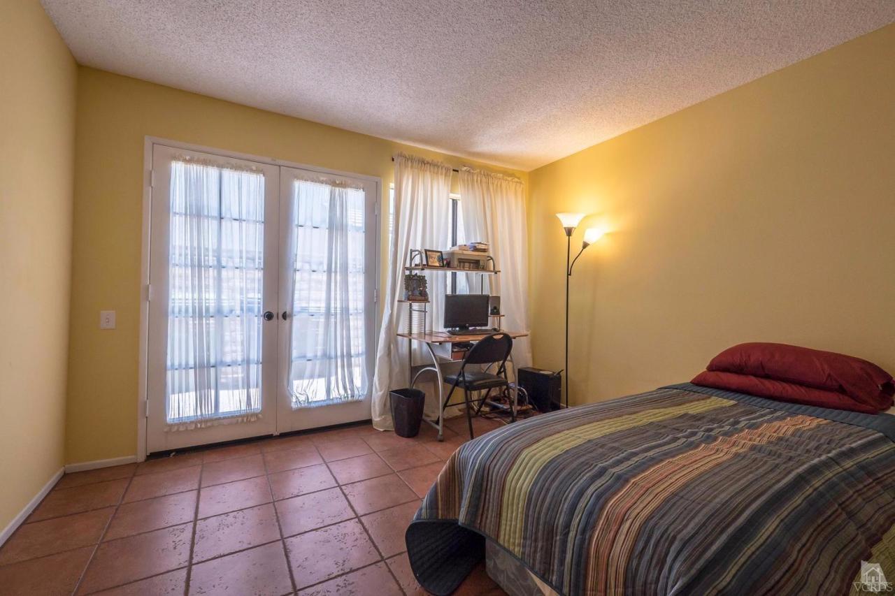 11529 East Buttercreek Road Moorpark, CA 93021 - Photo 18 of 36 a bedroom with a bed and a lamp with window