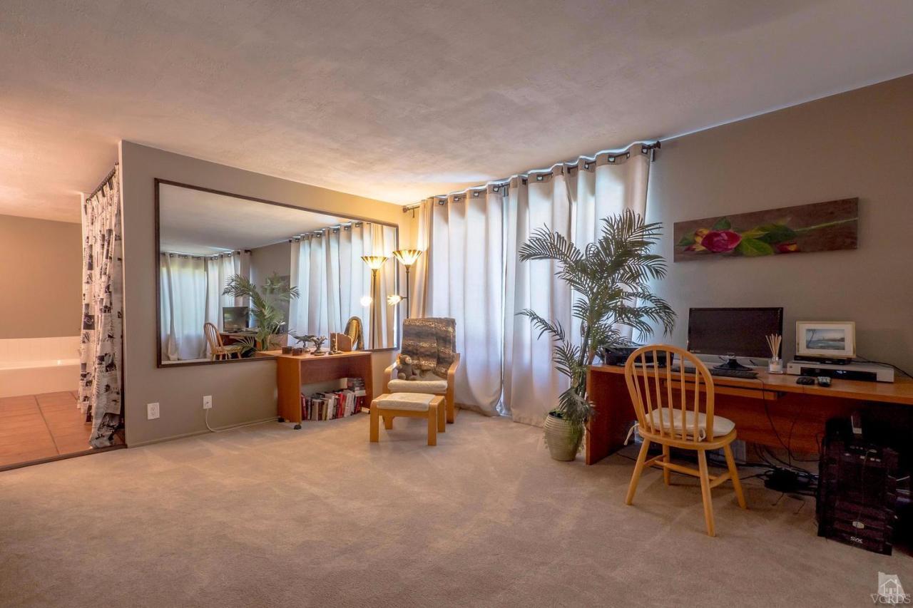 11529 East Buttercreek Road Moorpark, CA 93021 - Photo 24 of 36 a living room with furniture a fireplace and a large window
