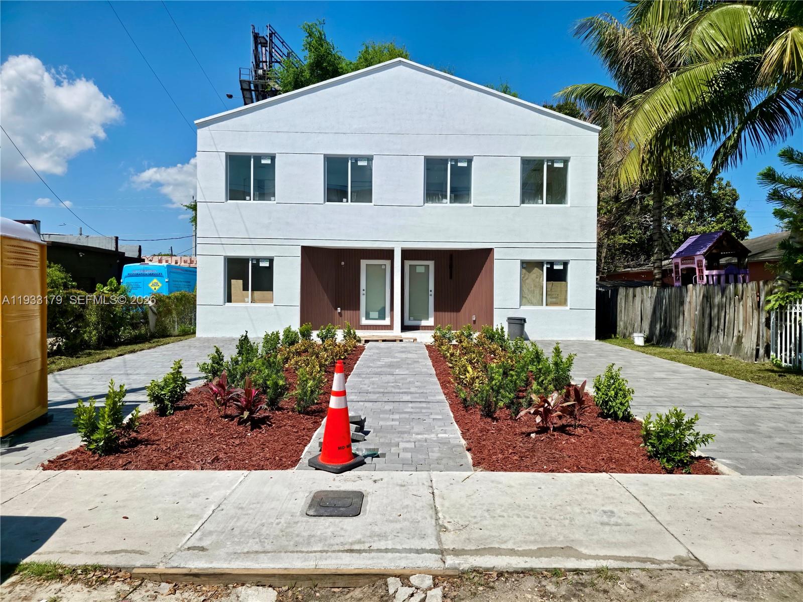 1629 Northwest 40th Street Miami, FL 33142 - Photo 1 of 17 a front view of a house with a yard