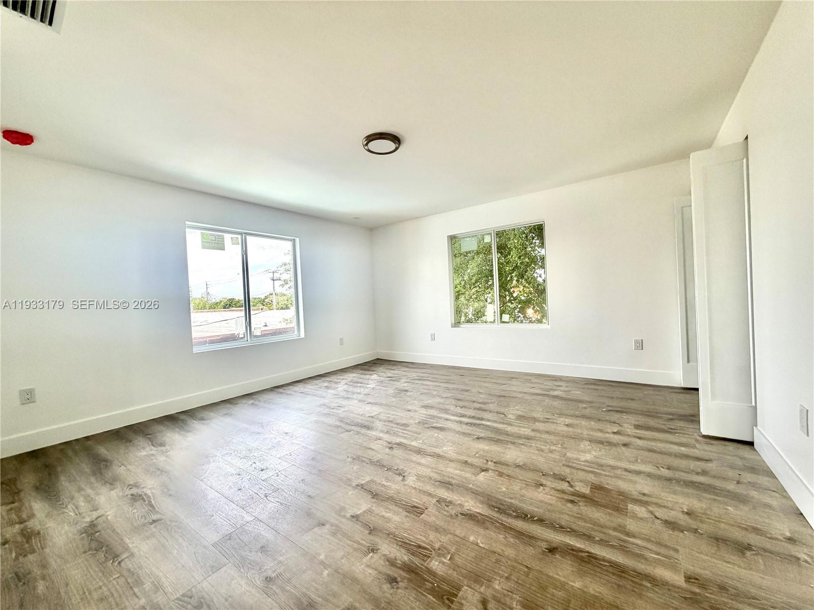 1629 Northwest 40th Street Miami, FL 33142 - Photo 11 of 17 an empty room with windows