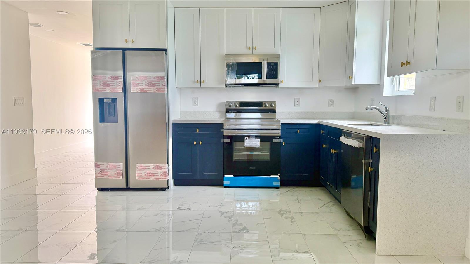 1629 Northwest 40th Street Miami, FL 33142 - Photo 4 of 17 a kitchen with stainless steel appliances granite countertop a refrigerator stove and sink