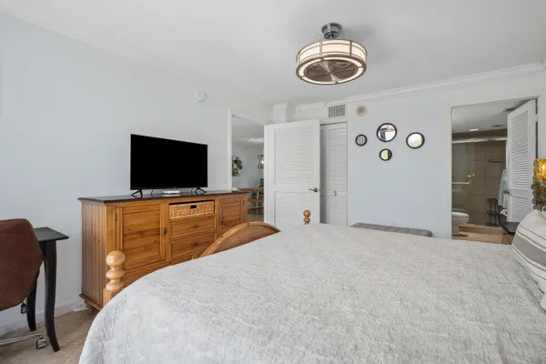 a bedroom with a bed and a flat screen tv