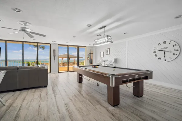 a living room with a table chairs and wooden floor