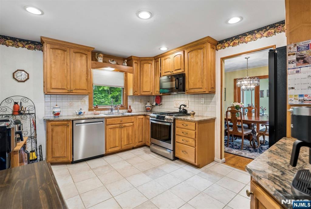 6 Waters Edge Butler, NJ 07405 - Photo 6 of 28 a kitchen with stainless steel appliances a stove a sink and a refrigerator