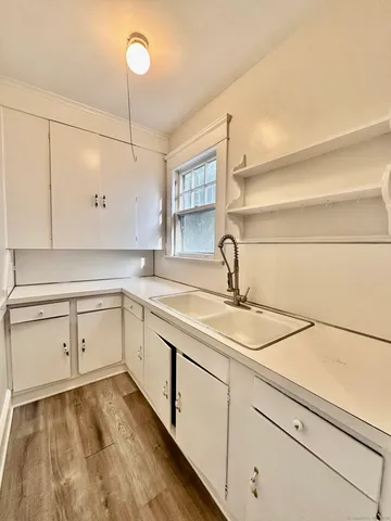 a kitchen with a sink cabinets and appliances