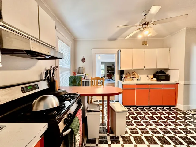 a kitchen with a table chairs and a stove