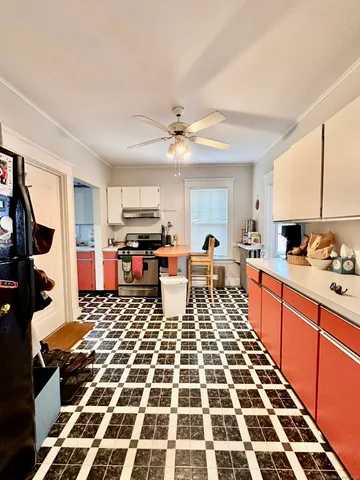 a large kitchen with a stove a sink and a microwave