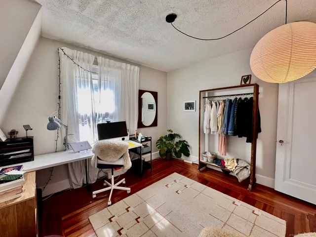 a living room with furniture and a mirror