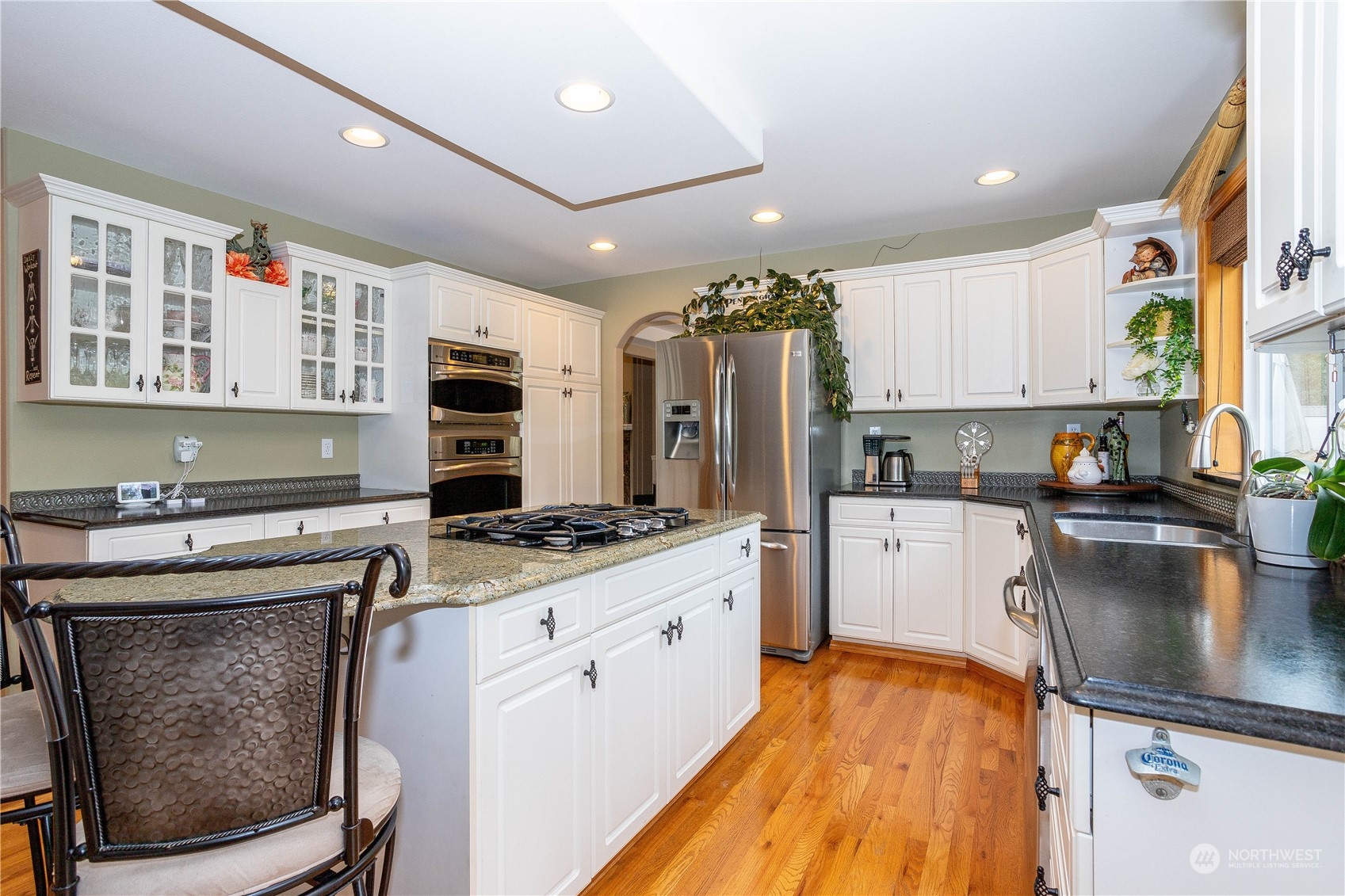 23408 Southeast 216th Way Maple Valley, WA 98038 - Photo 13 of 40 a kitchen with stainless steel appliances granite countertop a stove refrigerator sink and dishwasher with wooden floor
