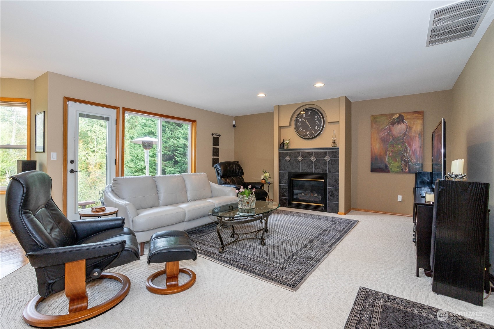 23408 Southeast 216th Way Maple Valley, WA 98038 - Photo 16 of 40 a living room with furniture a flat screen tv and a fireplace