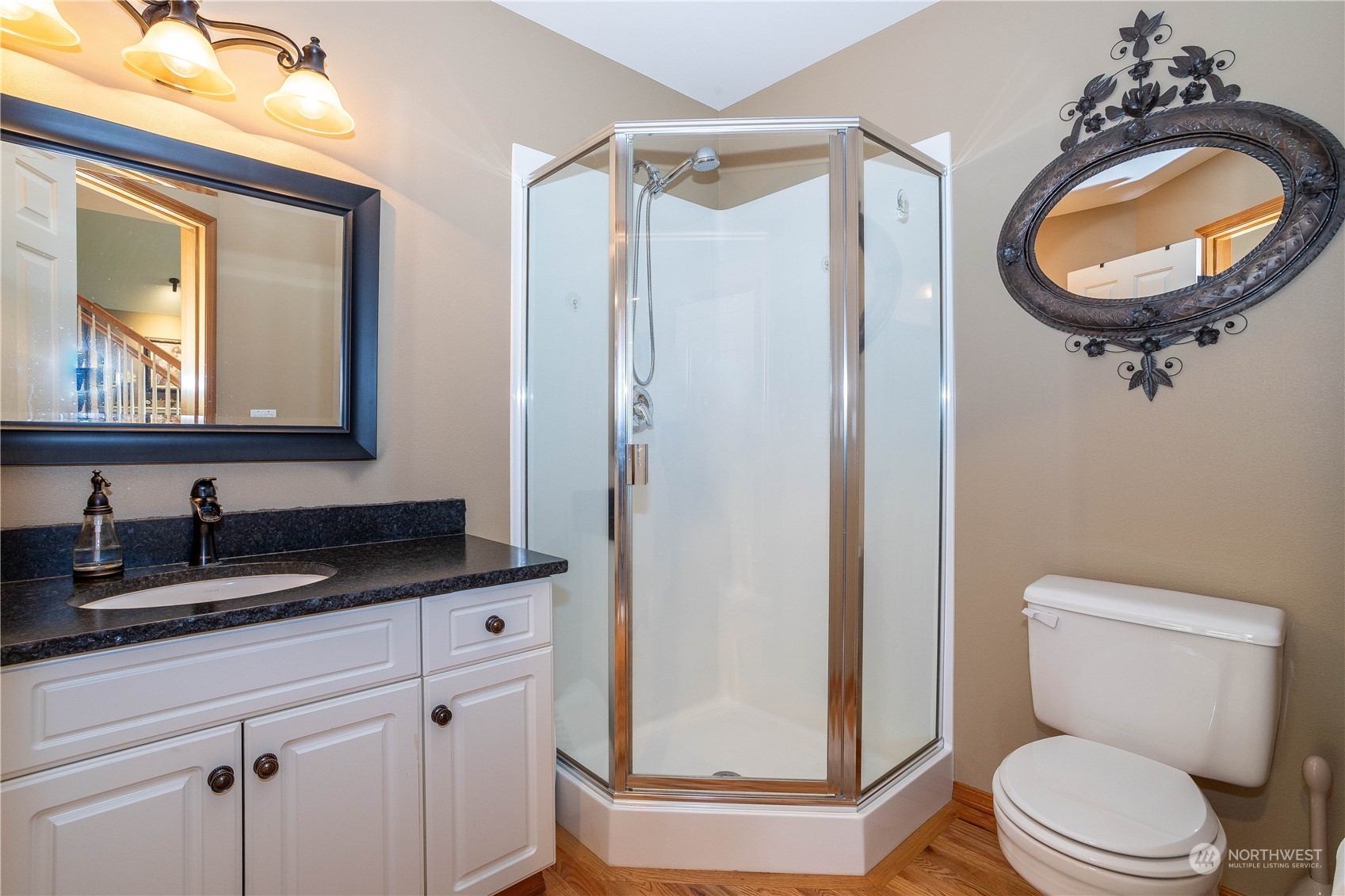 23408 Southeast 216th Way Maple Valley, WA 98038 - Photo 18 of 40 a bathroom with a toilet a sink a mirror and a shower