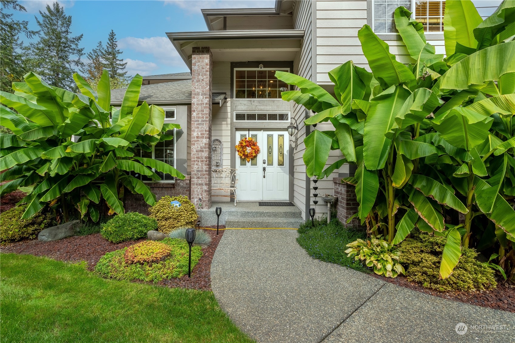 23408 Southeast 216th Way Maple Valley, WA 98038 - Photo 2 of 40 a sign that is sitting in front of a house with potted plants