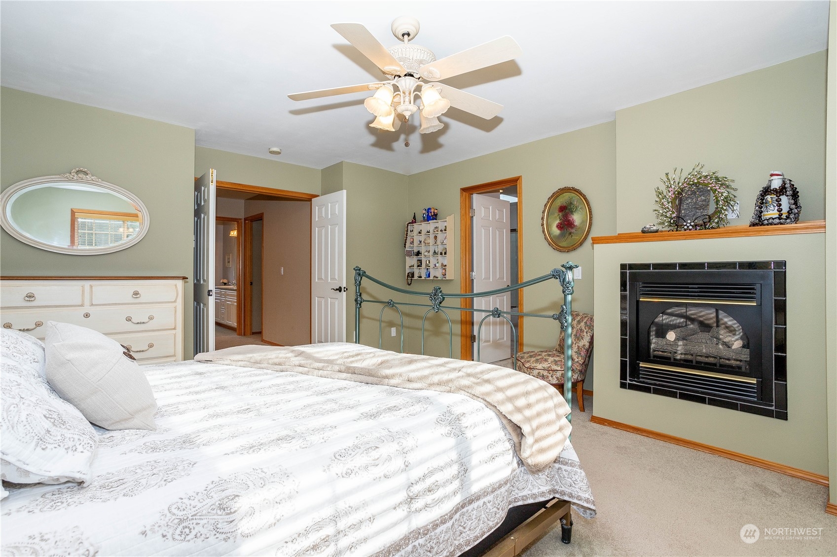 23408 Southeast 216th Way Maple Valley, WA 98038 - Photo 21 of 40 a bedroom with a bed and a chandelier