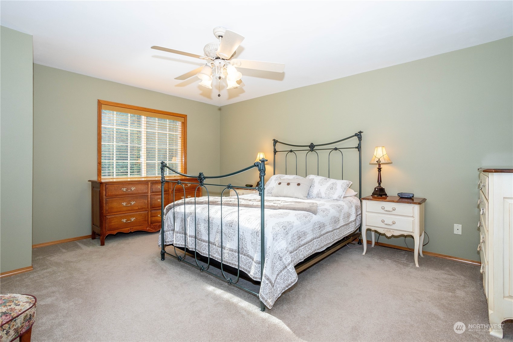 23408 Southeast 216th Way Maple Valley, WA 98038 - Photo 22 of 40 a bedroom with a bed and a chandelier