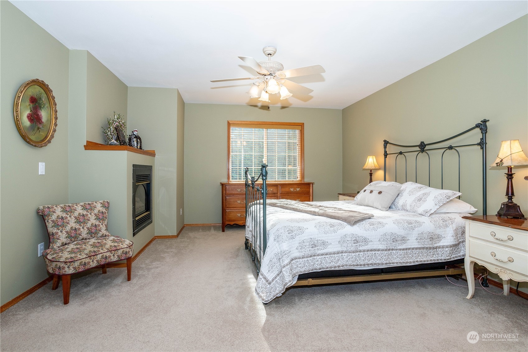 23408 Southeast 216th Way Maple Valley, WA 98038 - Photo 23 of 40 a bedroom with a bed and a chandelier