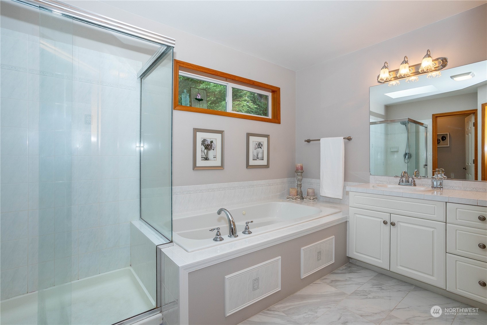23408 Southeast 216th Way Maple Valley, WA 98038 - Photo 24 of 40 a spacious bathroom with a bathtub a sink and a mirror