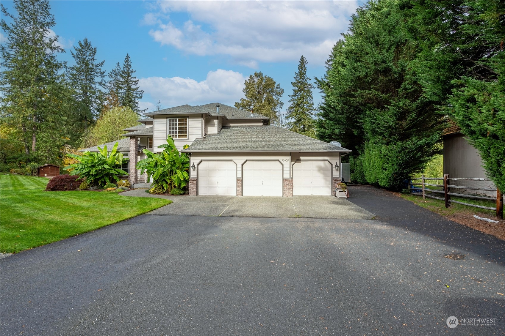 23408 Southeast 216th Way Maple Valley, WA 98038 - Photo 3 of 40 a front view of a house with a yard and garage