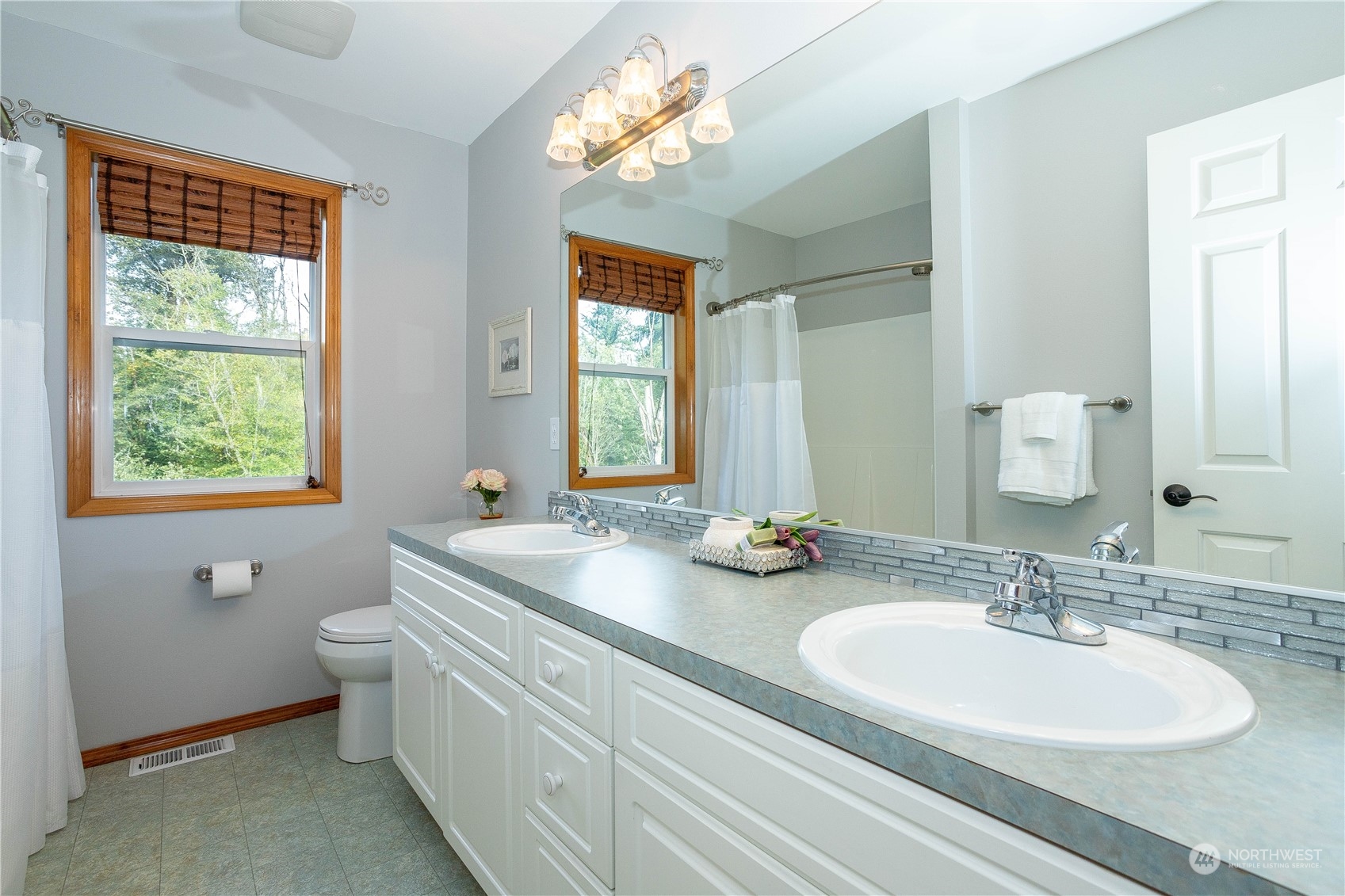 23408 Southeast 216th Way Maple Valley, WA 98038 - Photo 31 of 40 a bathroom with a double vanity sink toilet and a mirror