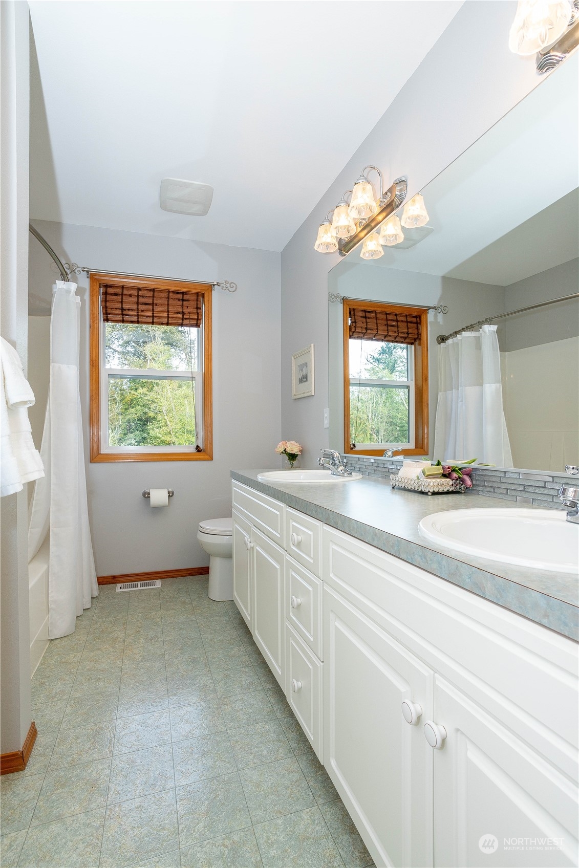 23408 Southeast 216th Way Maple Valley, WA 98038 - Photo 32 of 40 a bathroom with a double vanity sink window and a bathtub