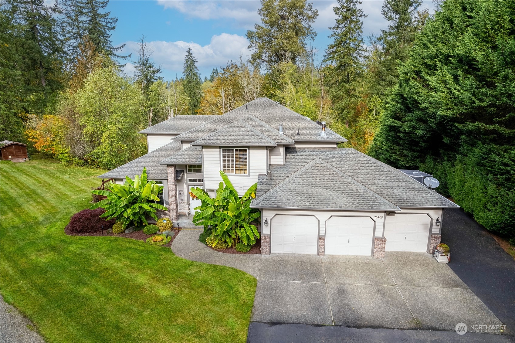 23408 Southeast 216th Way Maple Valley, WA 98038 - Photo 5 of 40 a front view of a house with a yard