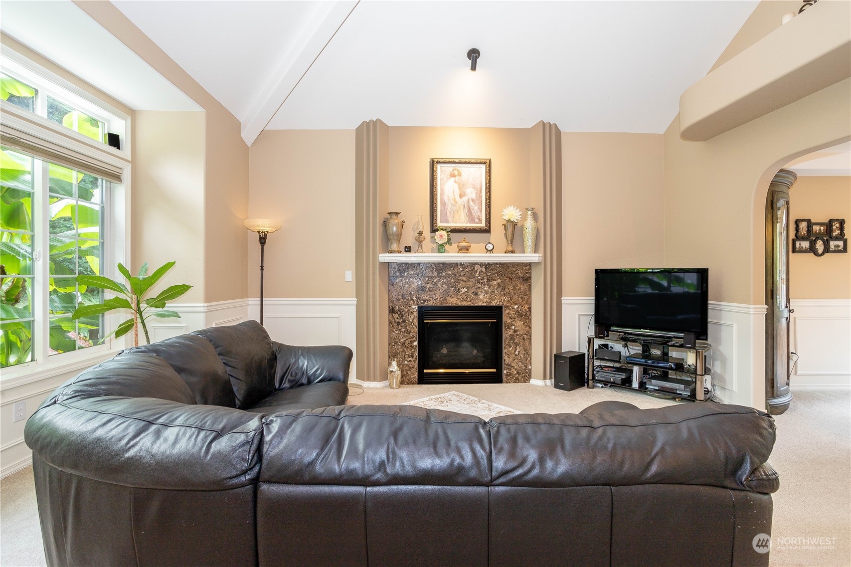 23408 Southeast 216th Way Maple Valley, WA 98038 - Photo 7 of 40 a living room with furniture a flat screen tv and a fireplace