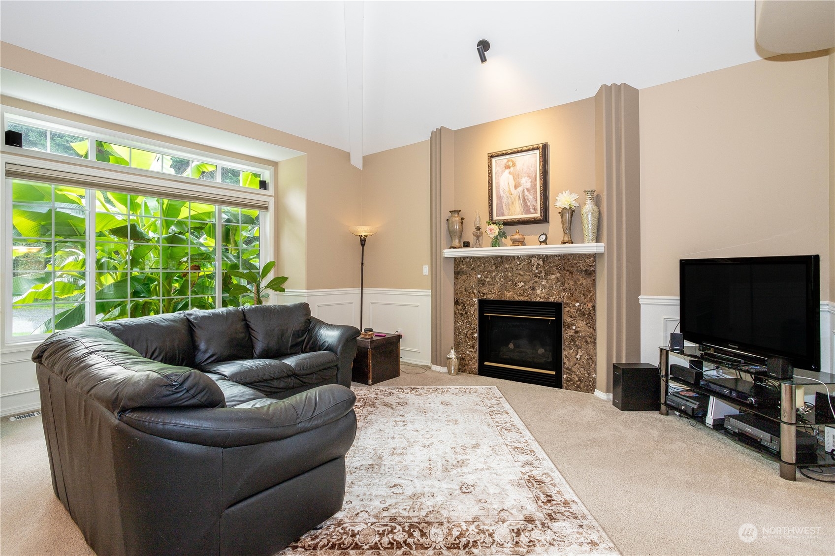 23408 Southeast 216th Way Maple Valley, WA 98038 - Photo 8 of 40 a living room with furniture a flat screen tv and a fireplace