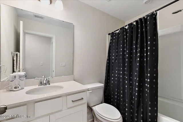 a bathroom with a sink a toilet a shower and a mirror