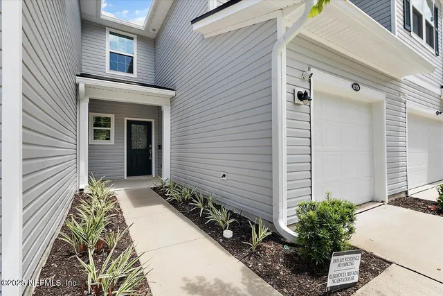 a potted plant sitting in front of a house