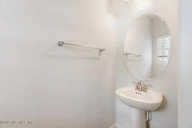 a bathroom with a sink a mirror and a shower