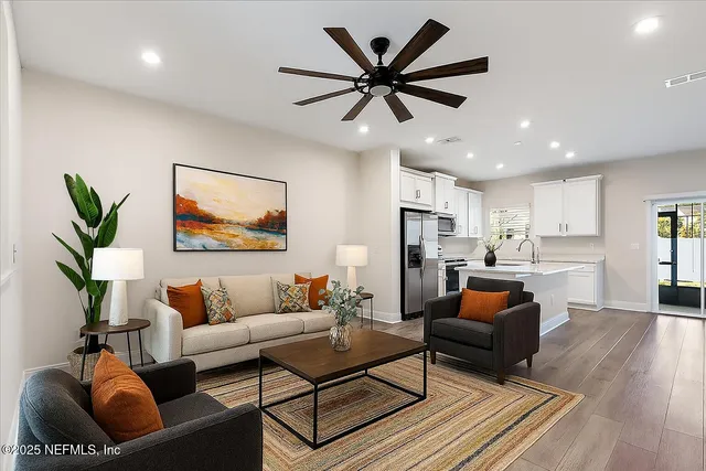 a living room with furniture and a wooden floor