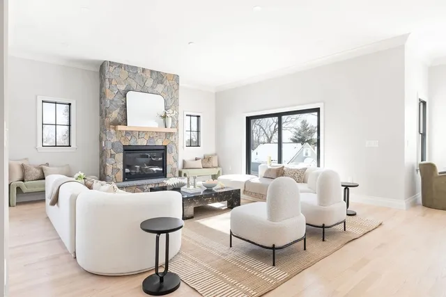 a living room with furniture kitchen view and a flat screen tv