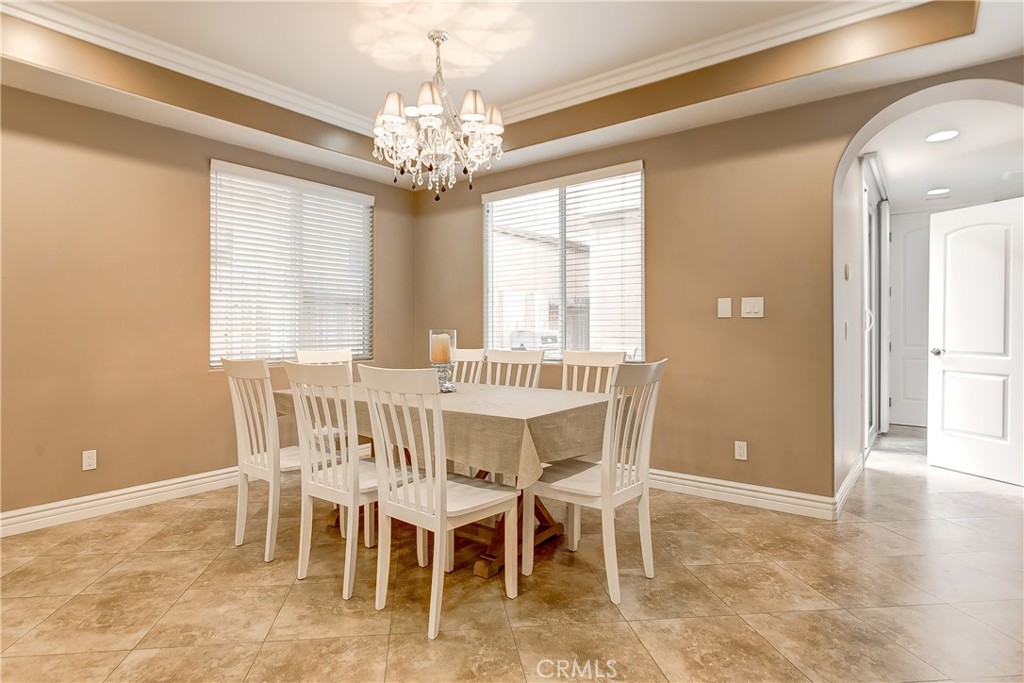 213 Baltimore Avenue Huntington Beach, CA 92648 - Photo 21 of 50 a view of a dining room with furniture and chandelier