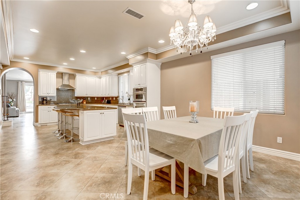 213 Baltimore Avenue Huntington Beach, CA 92648 - Photo 23 of 50 a kitchen with kitchen island granite countertop lots of white cabinets and stainless steel appliances