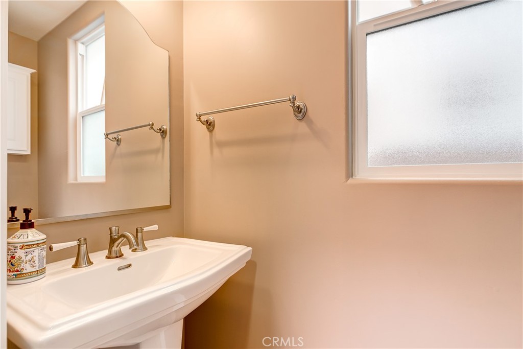 213 Baltimore Avenue Huntington Beach, CA 92648 - Photo 24 of 50 a bathroom with a sink and a mirror