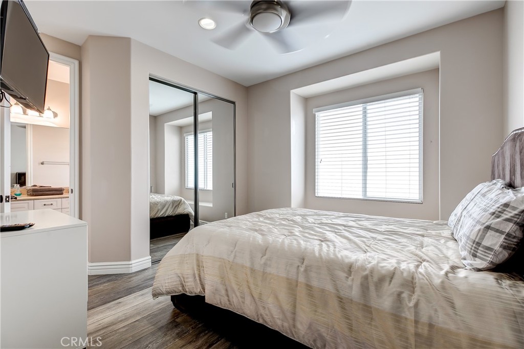 213 Baltimore Avenue Huntington Beach, CA 92648 - Photo 34 of 50 a bedroom with a bed and a chandelier