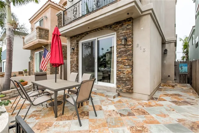 a view of a patio with table and chairs and potted plants