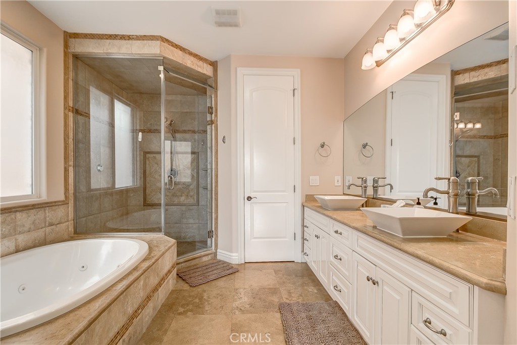 213 Baltimore Avenue Huntington Beach, CA 92648 - Photo 42 of 50 a spacious bathroom with a tub sink shower and mirror
