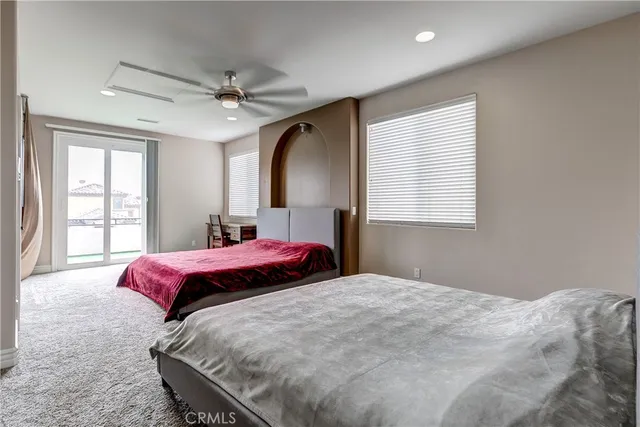 a bedroom with a large bed and a window