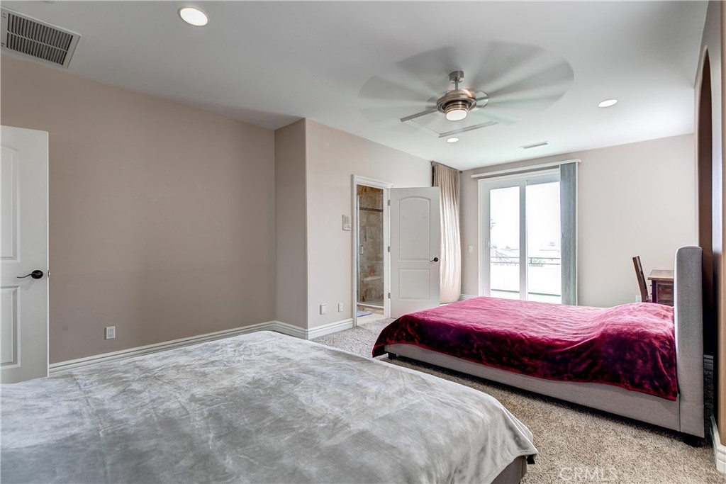 213 Baltimore Avenue Huntington Beach, CA 92648 - Photo 46 of 50 a bedroom with a large bed and a chandelier