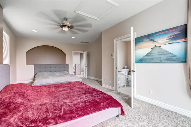 a bedroom with a large bed and a chandelier