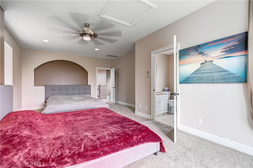 213 Baltimore Avenue Huntington Beach, CA 92648 - Photo 47 of 50 a bedroom with a large bed and a chandelier