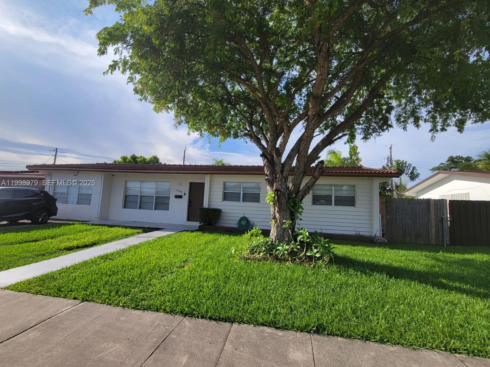 a front view of house with yard and green space