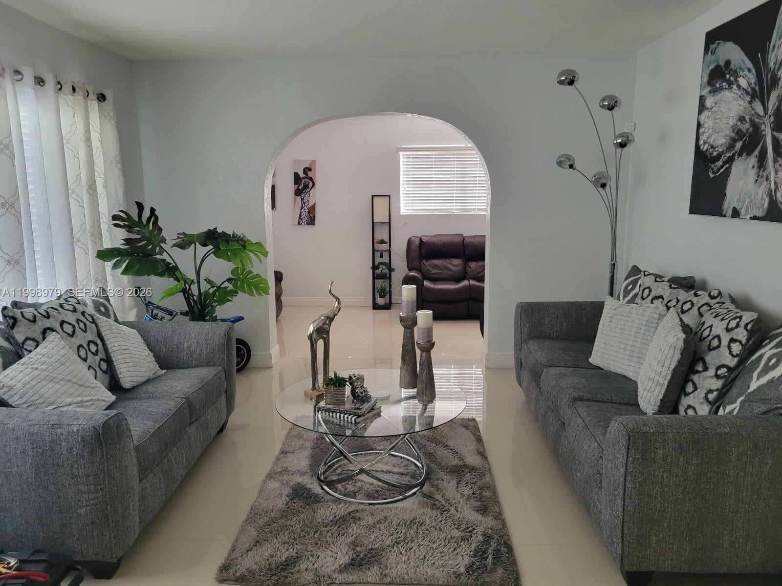 8245 Southwest 43rd Street Miami, FL 33155 - Photo 12 of 24 a living room with furniture a couch and a potted plant