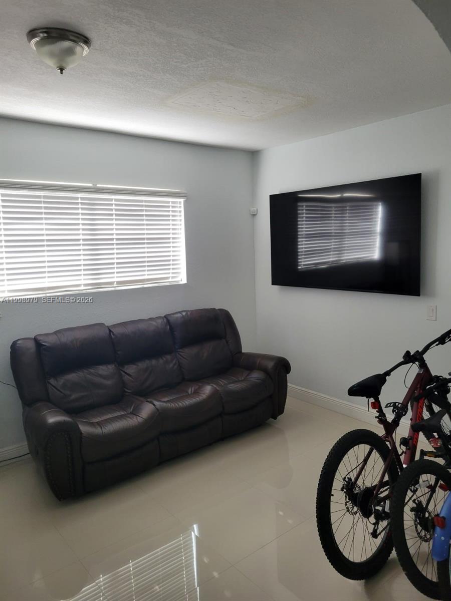 8245 Southwest 43rd Street Miami, FL 33155 - Photo 16 of 24 a living room with furniture and a flat screen tv