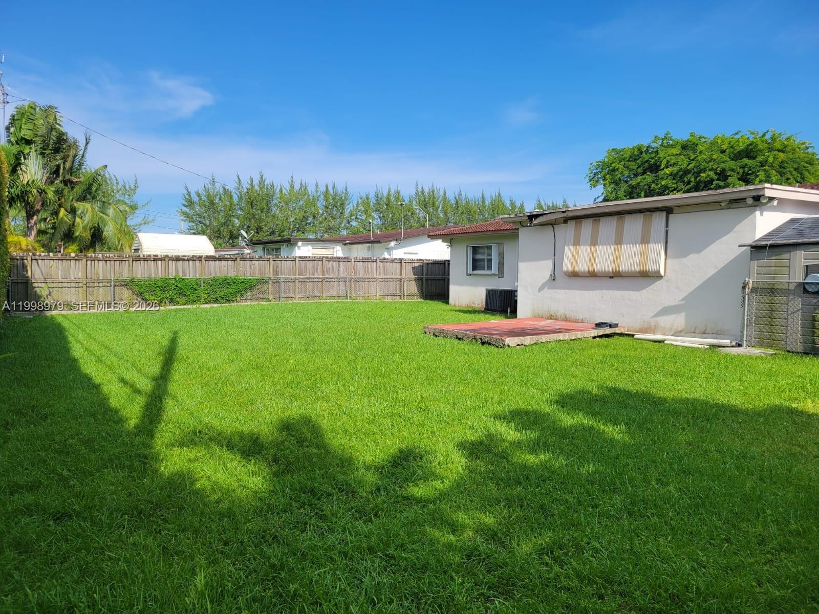 8245 Southwest 43rd Street Miami, FL 33155 - Photo 22 of 24 a view of a house with a yard and sitting area