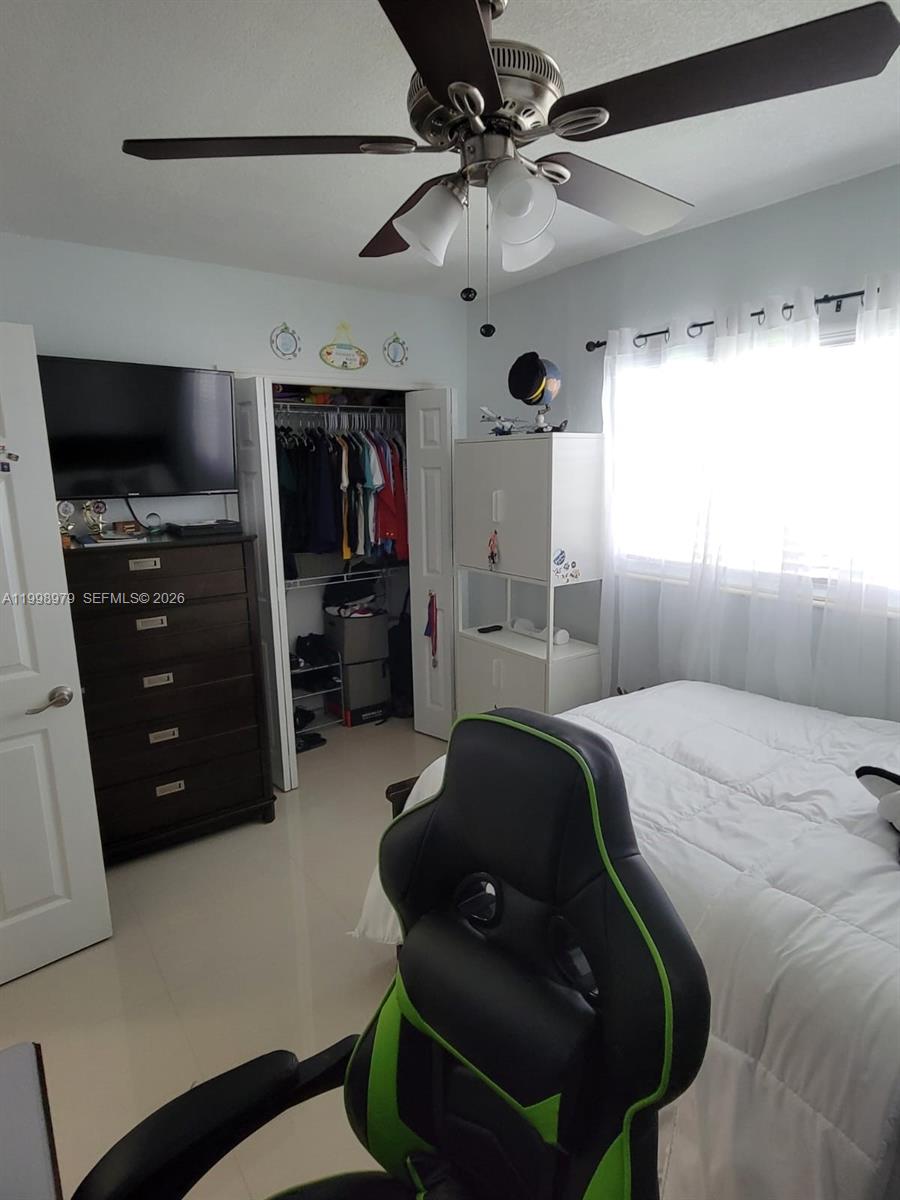 8245 Southwest 43rd Street Miami, FL 33155 - Photo 4 of 24 a bedroom with a bed and a television