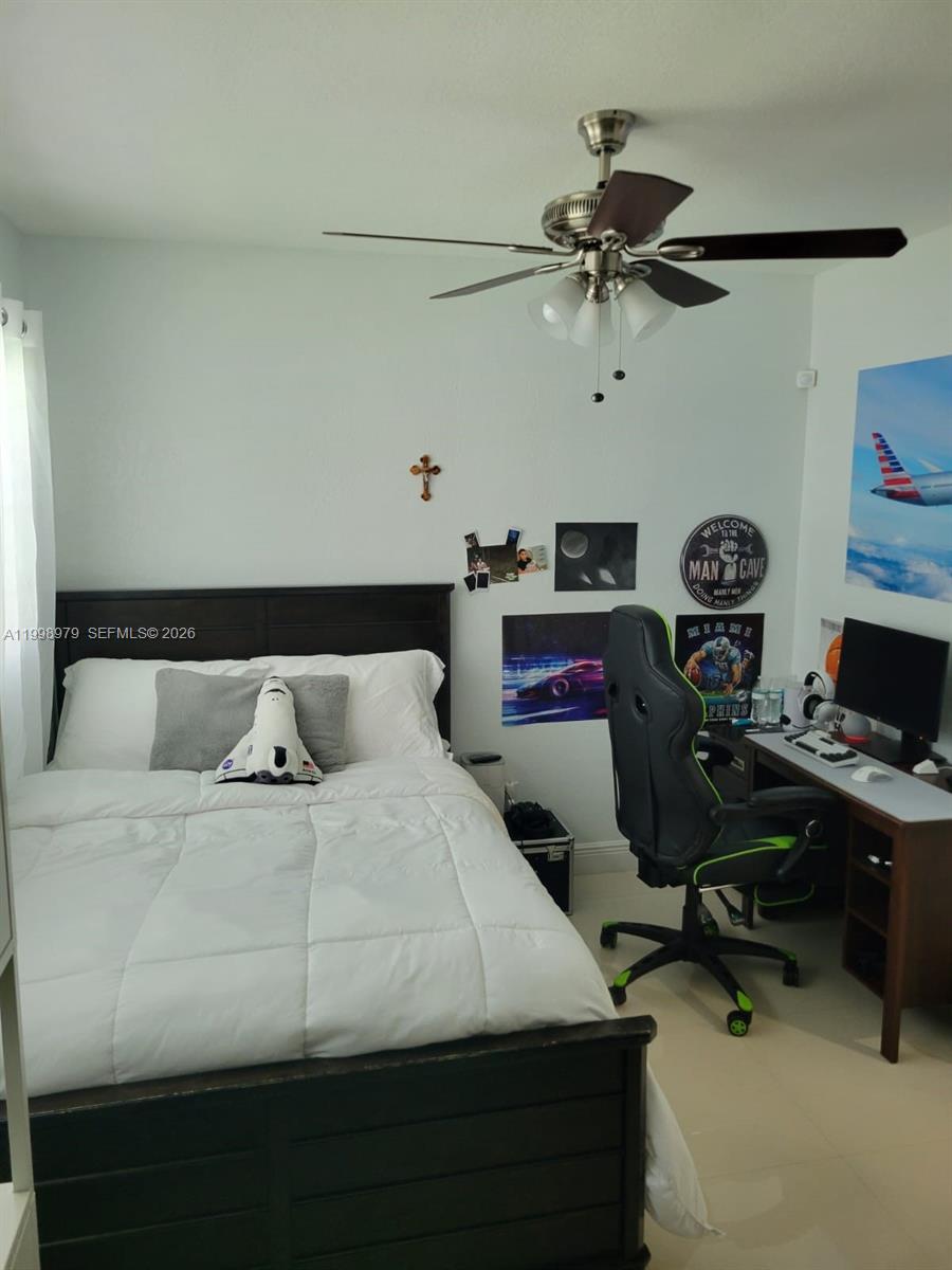 8245 Southwest 43rd Street Miami, FL 33155 - Photo 5 of 24 a bedroom with a bed and a chandelier