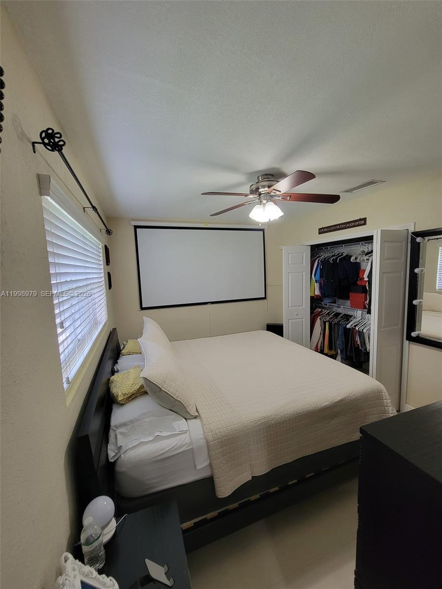 8245 Southwest 43rd Street Miami, FL 33155 - Photo 7 of 24 a bedroom with a bed and a large mirror