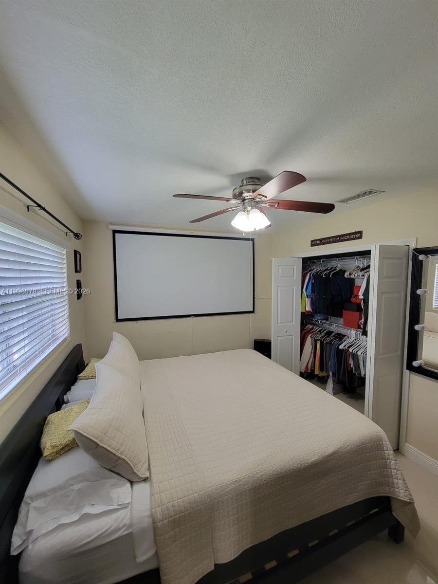 8245 Southwest 43rd Street Miami, FL 33155 - Photo 8 of 24 a bedroom with a bed and a chandelier